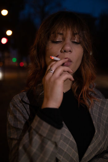 Portrait of a young woman smoking