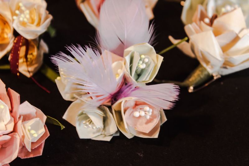 Close-up of artificial flowers over black background