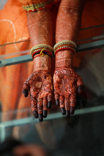 Low section of bride's hand with henna tattoo.. 
