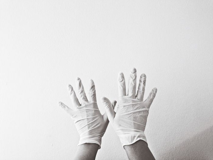 Close-up of hand over white background