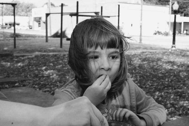 Cropped hand of mother with daughter having food