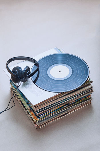 High angle view of headphones on records at table