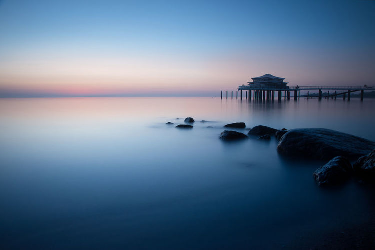 Scenic view of sea against sky at sunset