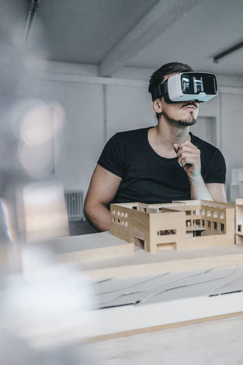 Man with architectural model and vr glasses