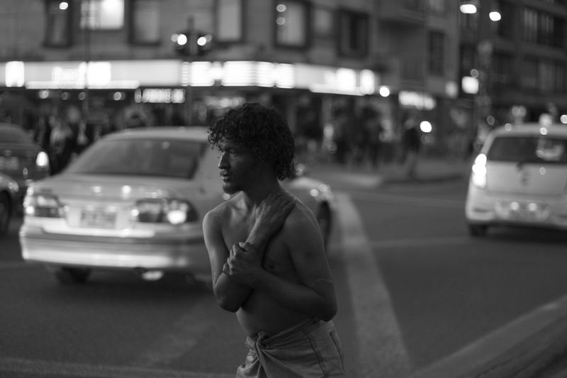 Shirtless beggar on street