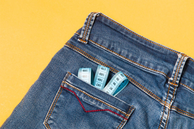 Close-up of measure tape in jeans pocket
