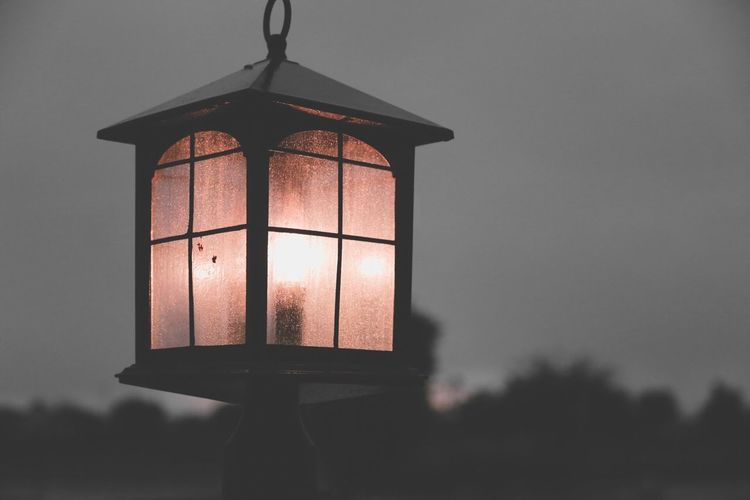 Low angle view of illuminated lantern against sky