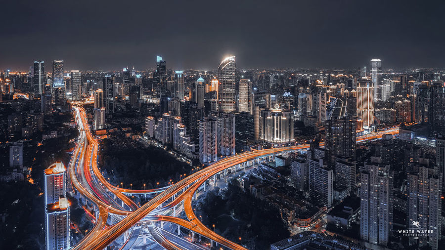 High angle view of illuminated city buildings at night