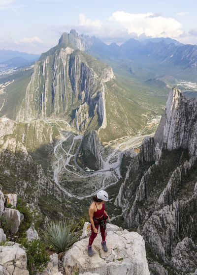 Full length of man on rocks against mountains