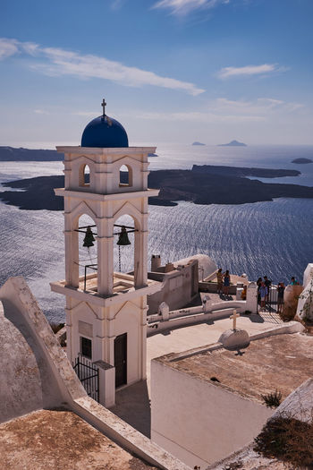 Anastasis church with its blue dome and tower in imerovigli village, santorini, greece