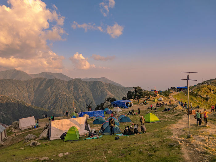 Group of people on mountain range against sky