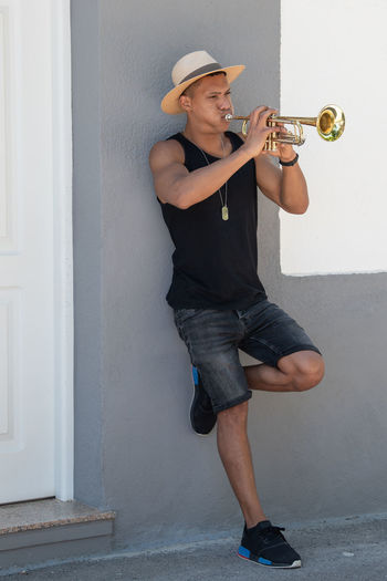 Full length of man playing trumpet