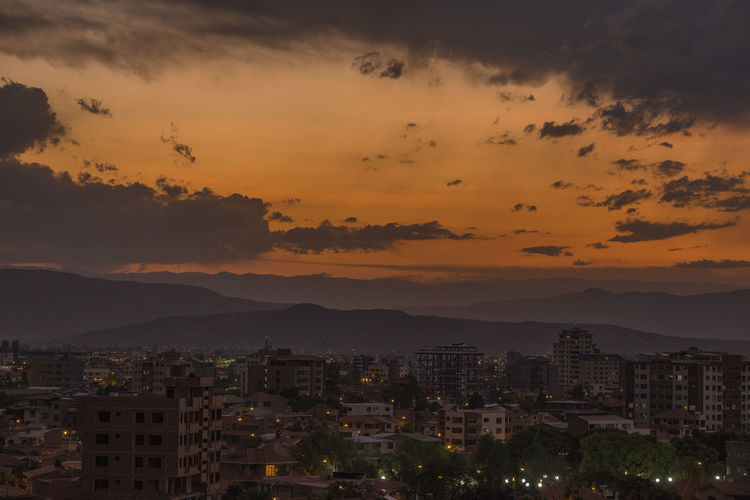 Aerial view of cityscape against sky during sunset