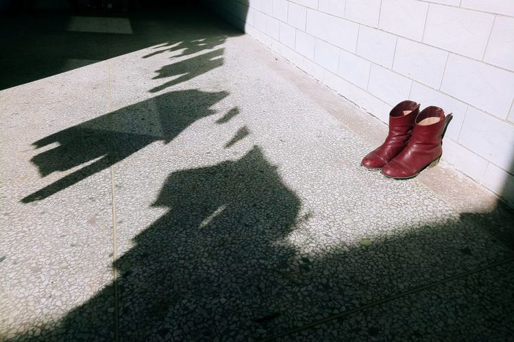 Shadow of woman on tiled floor