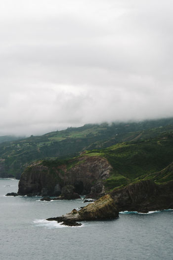 Scenic view of sea and mountains against sky