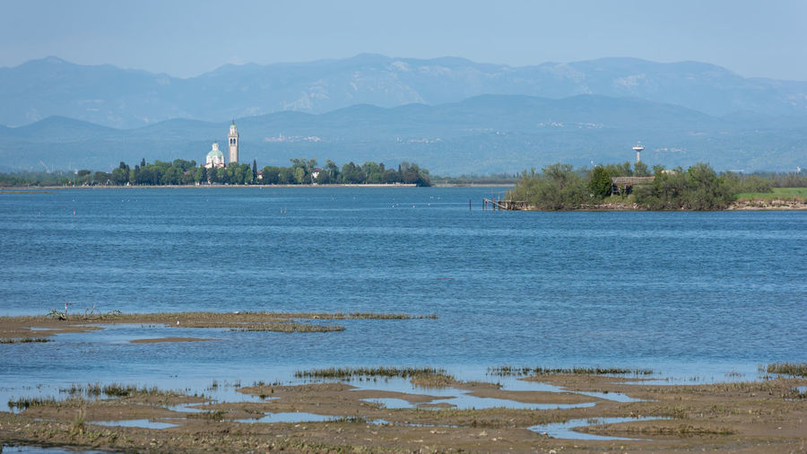 Scenic view of lake by building against sky