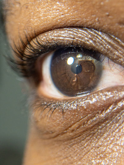 Close up of african american man dark brown eyes for use in ophthalmology optometry imagery