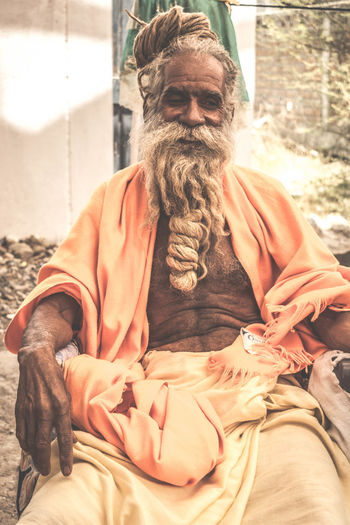 Midsection of man sitting outdoors
