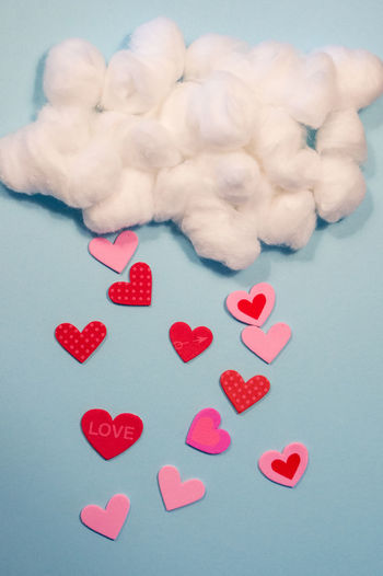 Optical illusion of heart shapes raining from cotton ball clouds