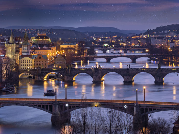 High angle view of arch bridges over river at night