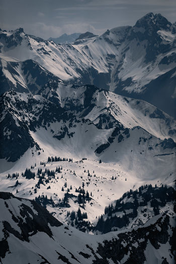 High angle view of snowcapped mountains against sky