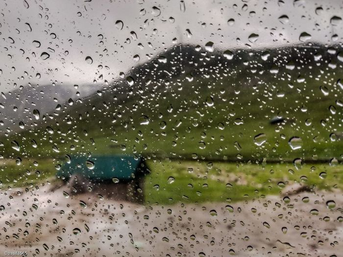 Raindrops on glass window during rainy season