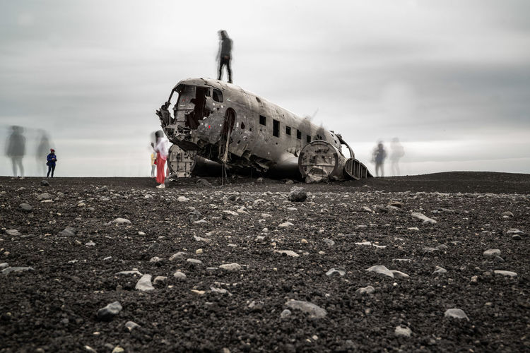 Abandoned airplane on field against sky