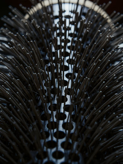 Close up of hairbrush bristles poking out of holes