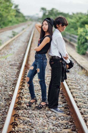 Full length of woman walking on railroad track
