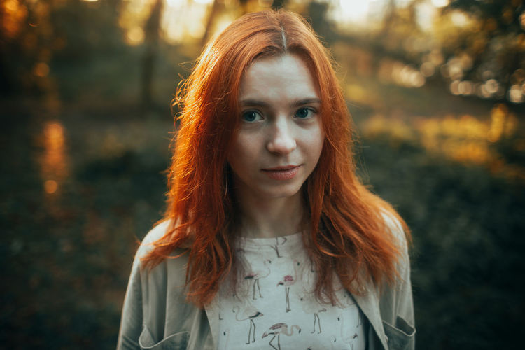 Portrait of young woman standing outdoors
