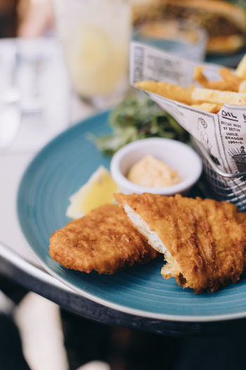 Close-up of food in plate on table, fish and chips 