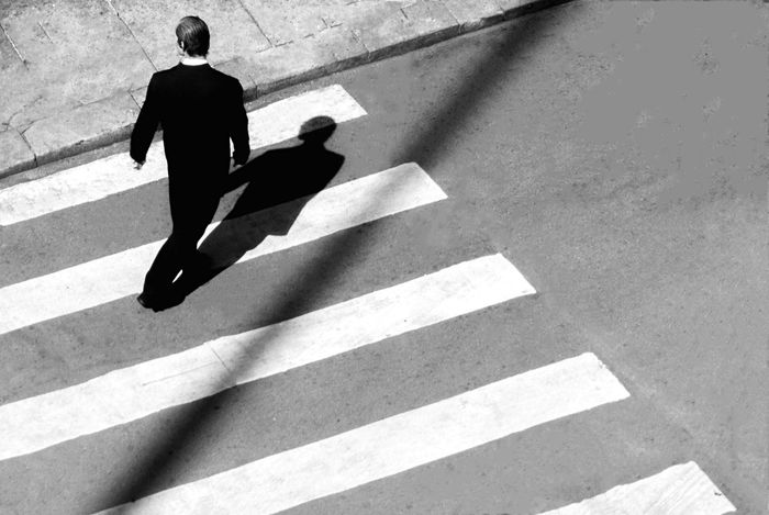 High angle view of man crossing the road