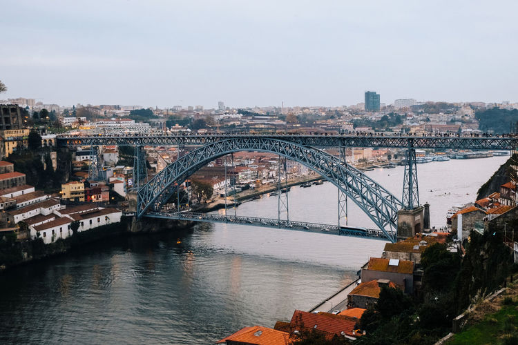 Iron bridge over douro river against buildings in porto portugal 