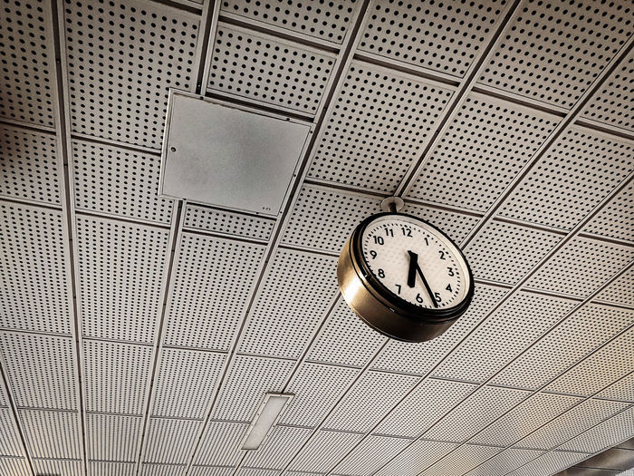 Low angle view of clock on ceiling