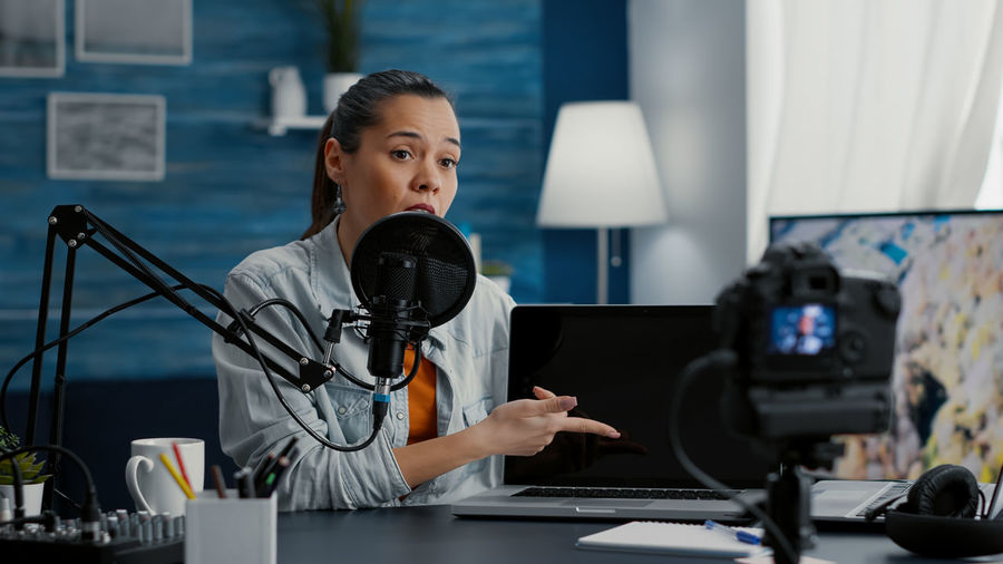 Portrait of young woman using mobile phone in office