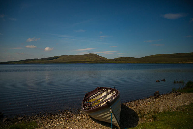 Boat moored on the banks of a tranquil lake in the northwest of ireland