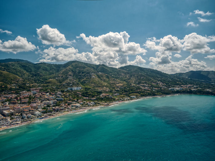 Scenic view of sea and mountains against sky