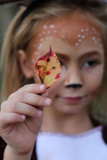 Close-up of girl holding leaf