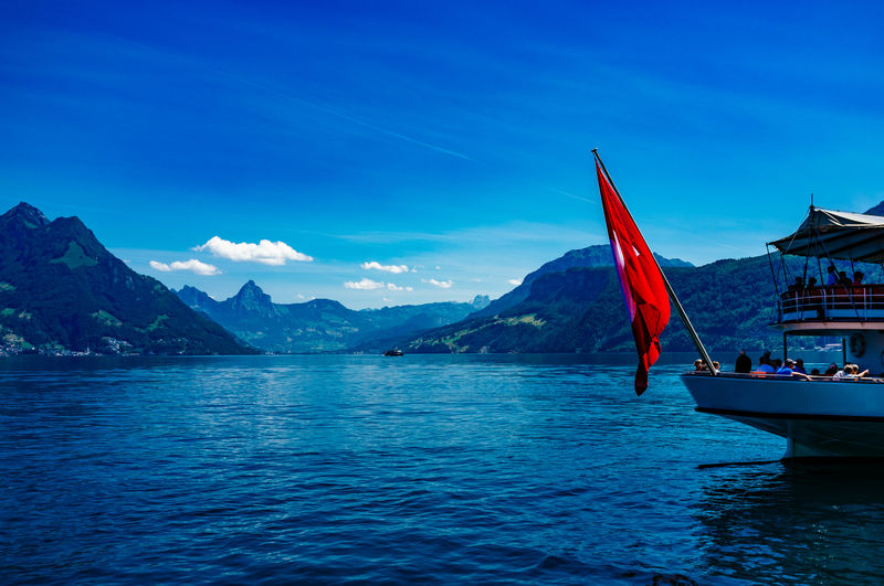 Passenger craft with flag on lake