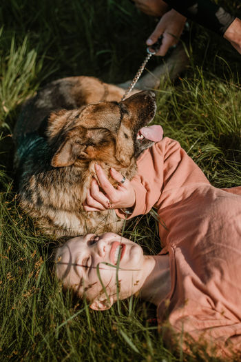 Midsection of man eating grass in field