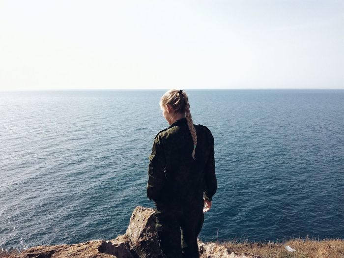 Woman standing by seashore