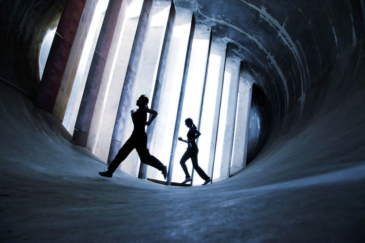 Two Women working out in an old abandoned Wind Tunnel: Futuristic Running Action Action Shot Dark Darkness And Light EyeEmNewHere Futuristic Healthy Lifestyle Jogging Jogging Time Lifestyles Modern Motion Capture People Running Sports Wind Tunnel Women Women Who Inspire You Young Adult Young Women