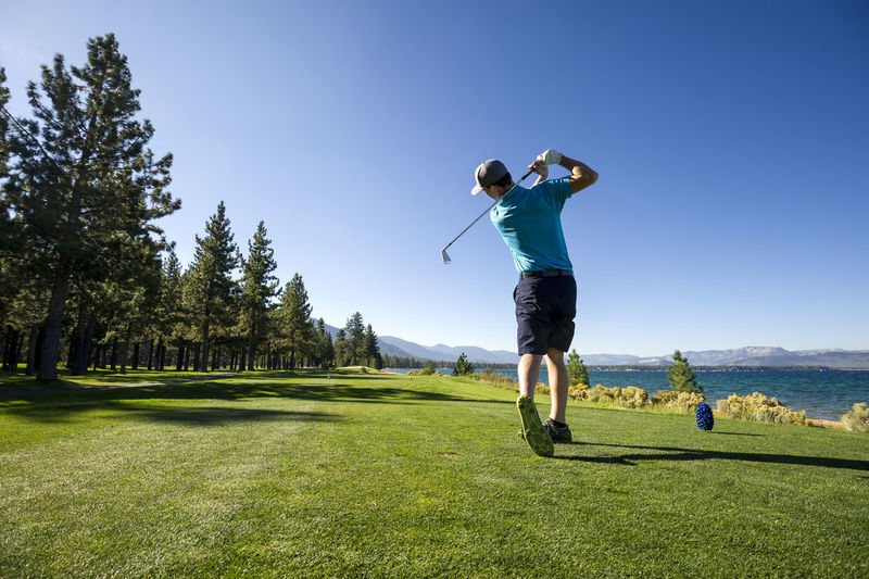 A man teeing off at edgewood tahoe in stateline, nevada.