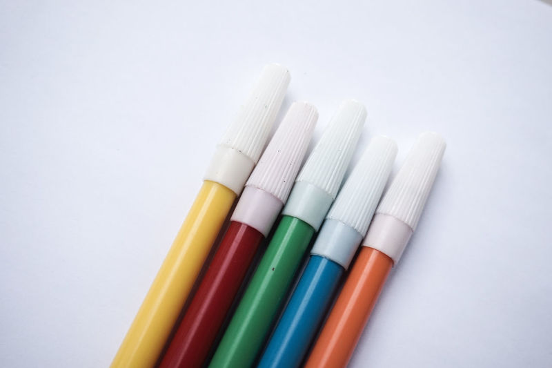 Close-up of colorful felt tip pens on white background