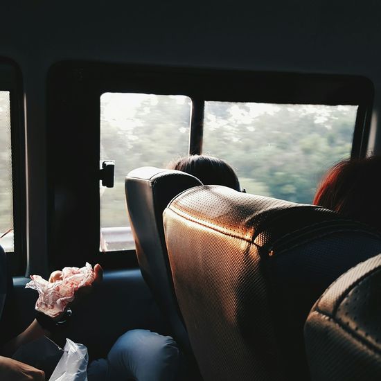 Cropped image of people traveling in bus