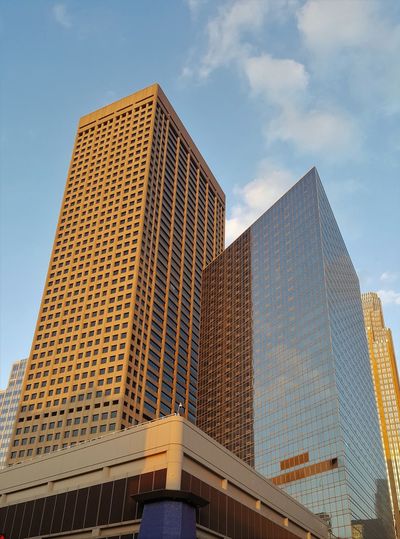 Golden light on building against a blue sky 