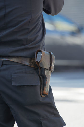 Close-up of man with gun holster