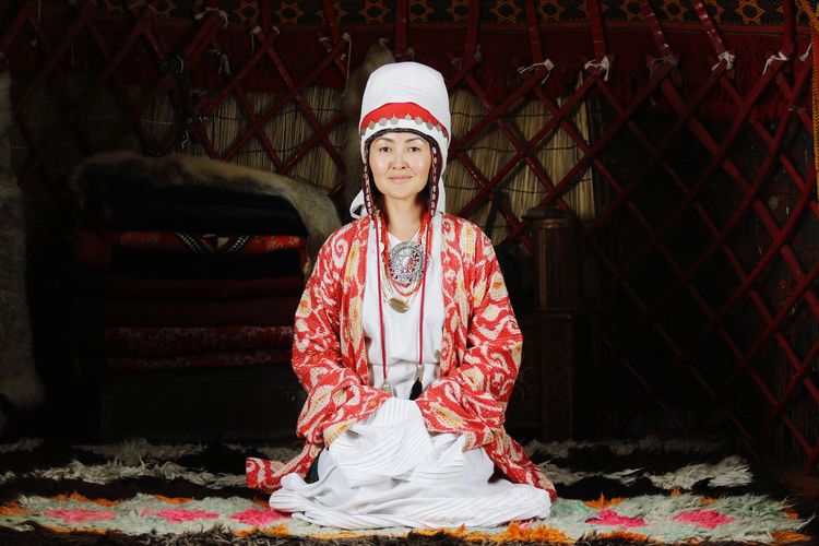 Portrait of young woman in a traditional kyrgyz outfit