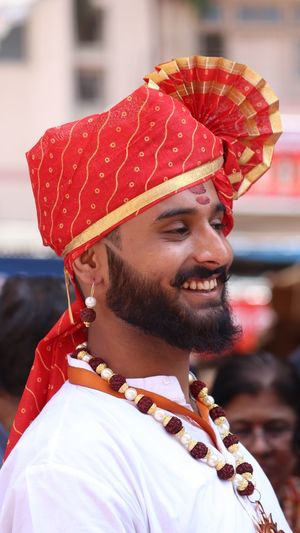 Side view of smiling bearded man wearing turban