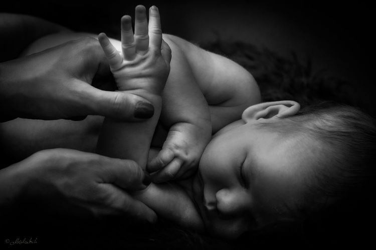 Hands, hands and fingers of a woman and small hands of a newborn. artistic studio , love style